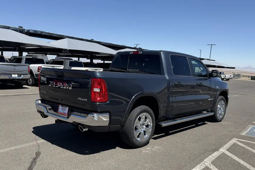 Rear view of the RAM 1500 Crew Cab showing the 5'7" box, chrome step bumper, and dual rear exhaust with bright tips.