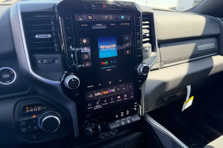 Interior of the 2026 RAM 1500 dashboard highlighting the 12-inch Uconnect touchscreen system and leather-wrapped steering wheel.