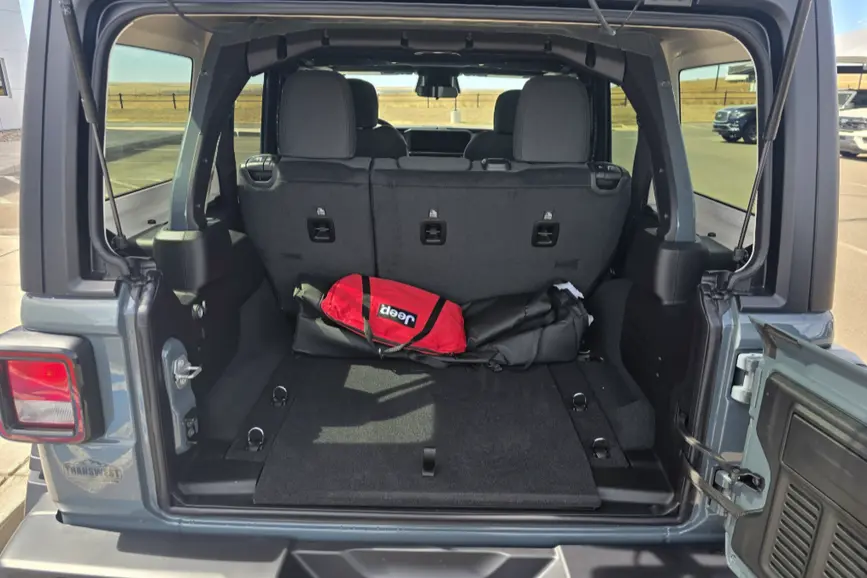 Rear angle view of the 2026 Jeep Wrangler Willys showing the swing-out cargo gate and trunk space.