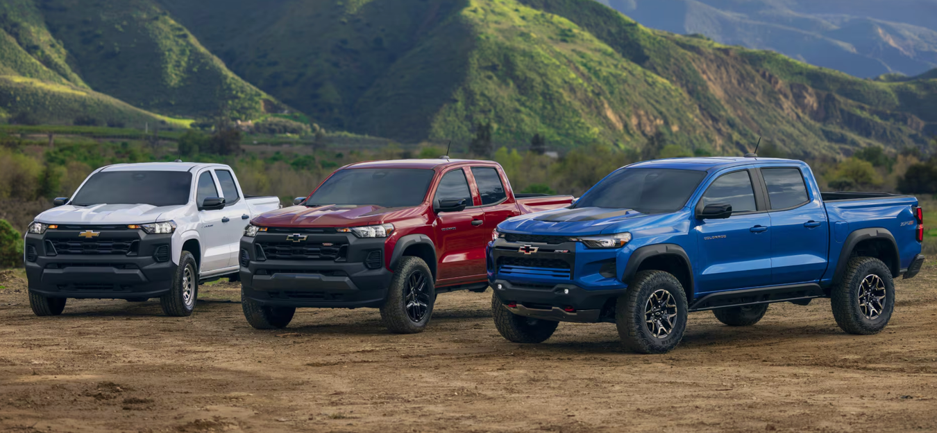 Three Chevy pickups outside