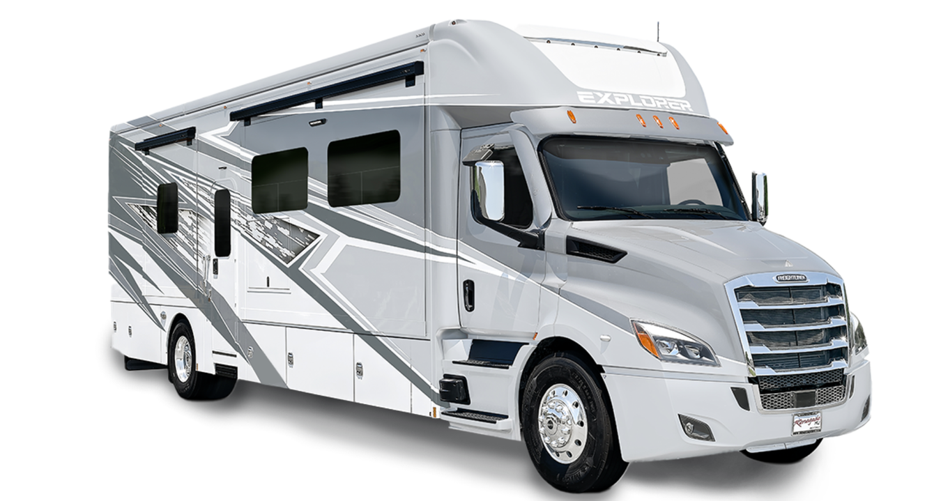Exterior of the 2026 Renegade Explorer Super C motorhome in silver and gray full-body paint. Built on a Freightliner chassis with bold graphics and large side windows.