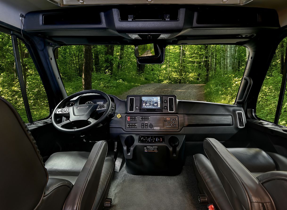 2026 Renegade Verona cockpit with touchscreen controls, leather captain chairs, and wide front view.