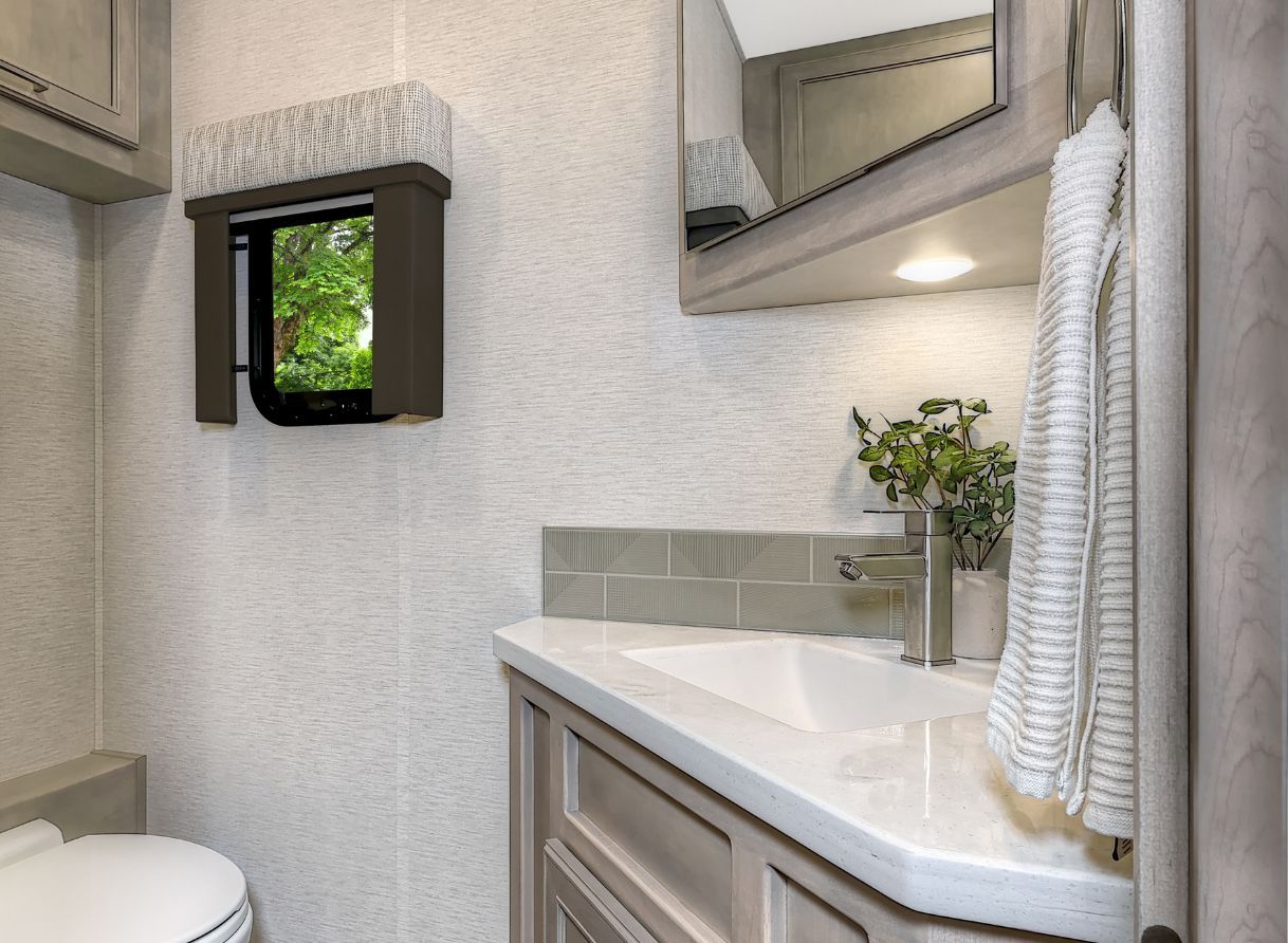 2026 Renegade Verona half bathroom with vanity sink, solid-surface countertop, and modern fixtures.