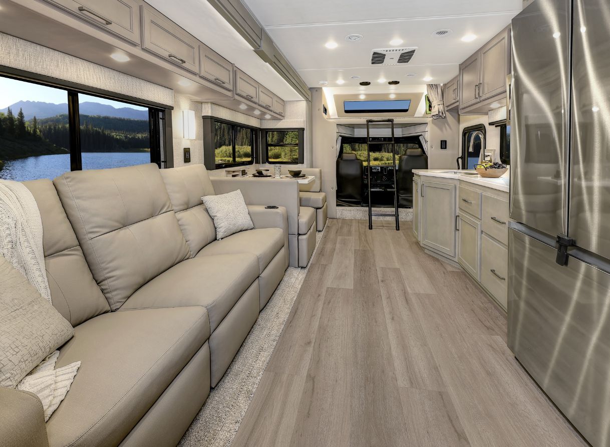 2026 Renegade Verona interior view from kitchen to bedroom with full-wall slide and entertainment center.