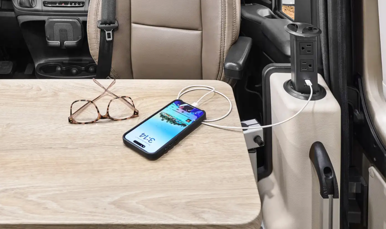 A phone charging in the Winnebago Travato