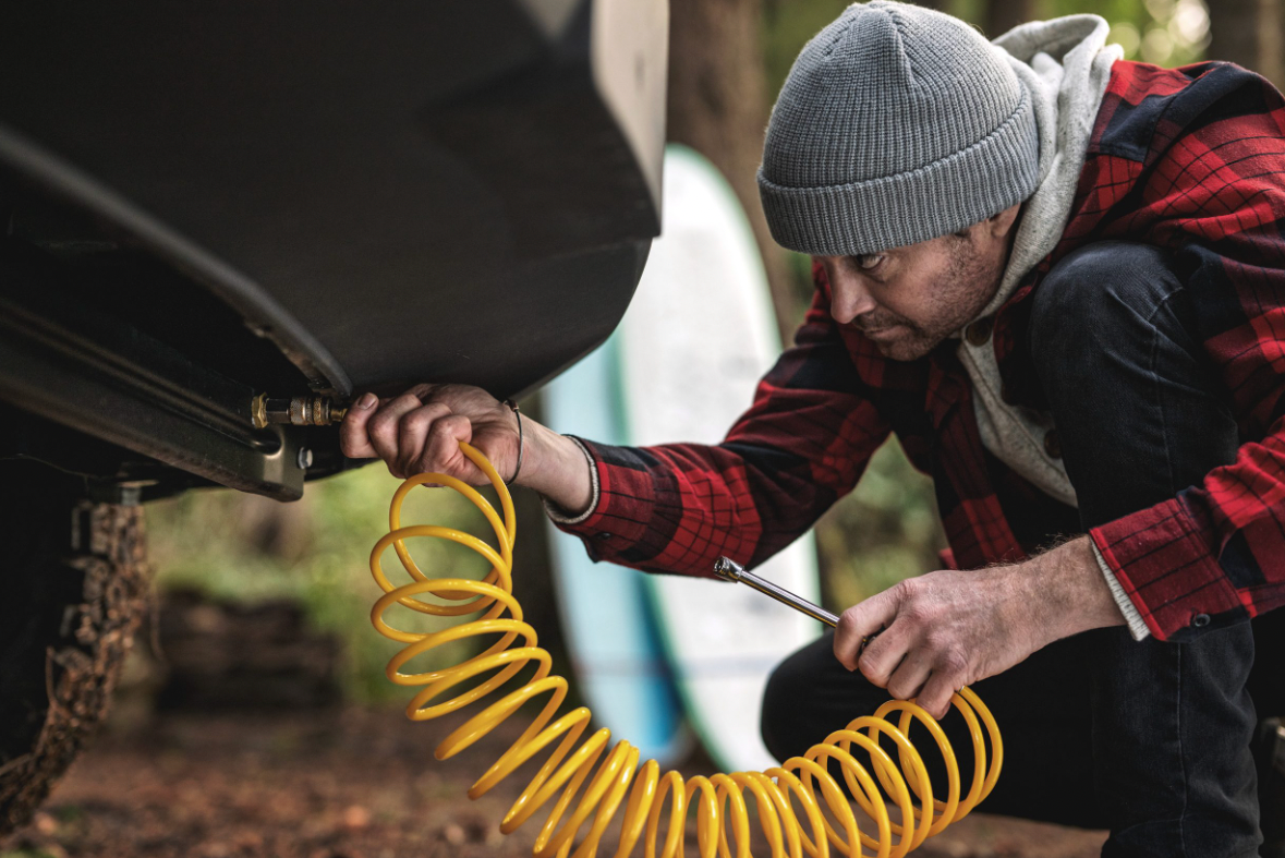 A traveler uses an air compressor on a 2025 Tiffin GH1