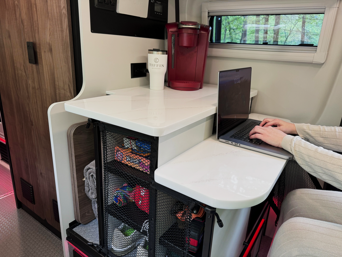 Someone uses a laptop at the Tiffin GH1&#039;s adventure bar