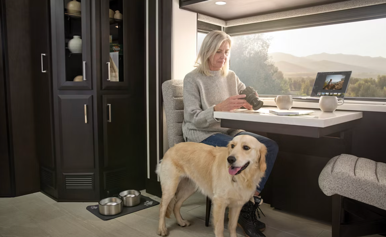 A woman and a dog enjoy time inside the New Aire
