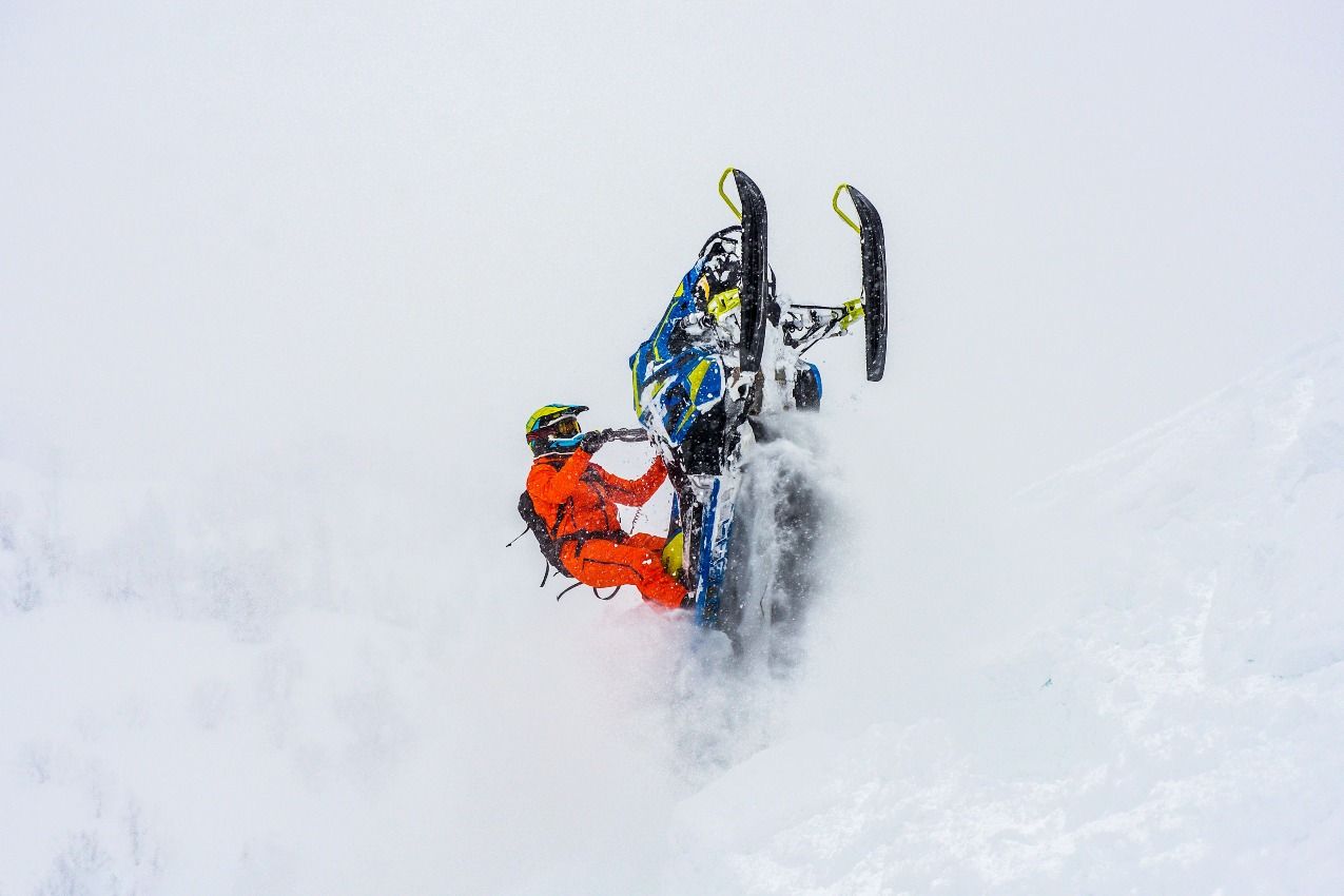 Snowmobile doing a wheelie in deep snow