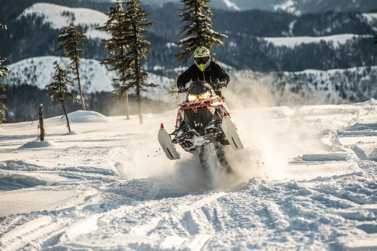 snowmobile going fast on a fresh trail
