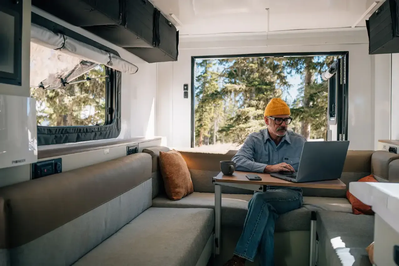 Man working at a computer inside an RV