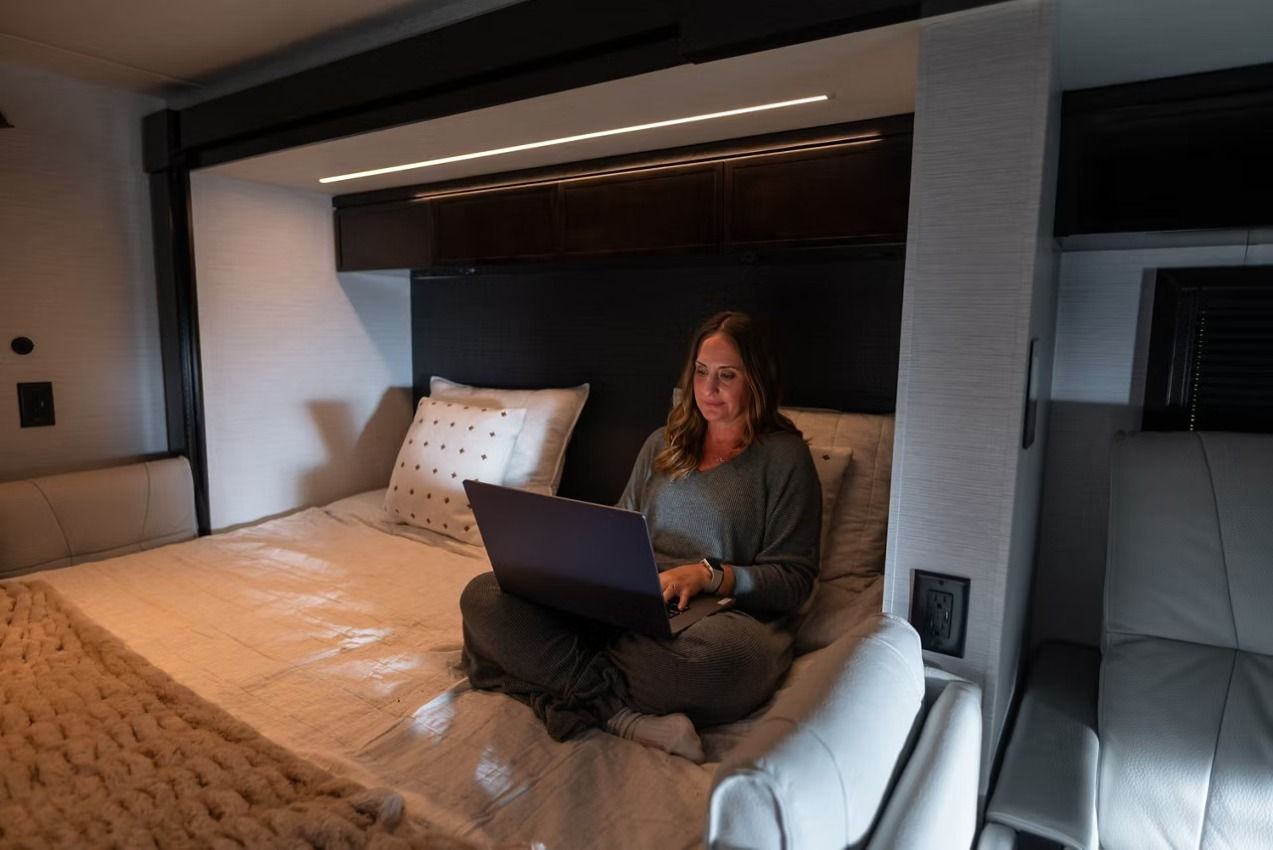 Woman on laptop in bed