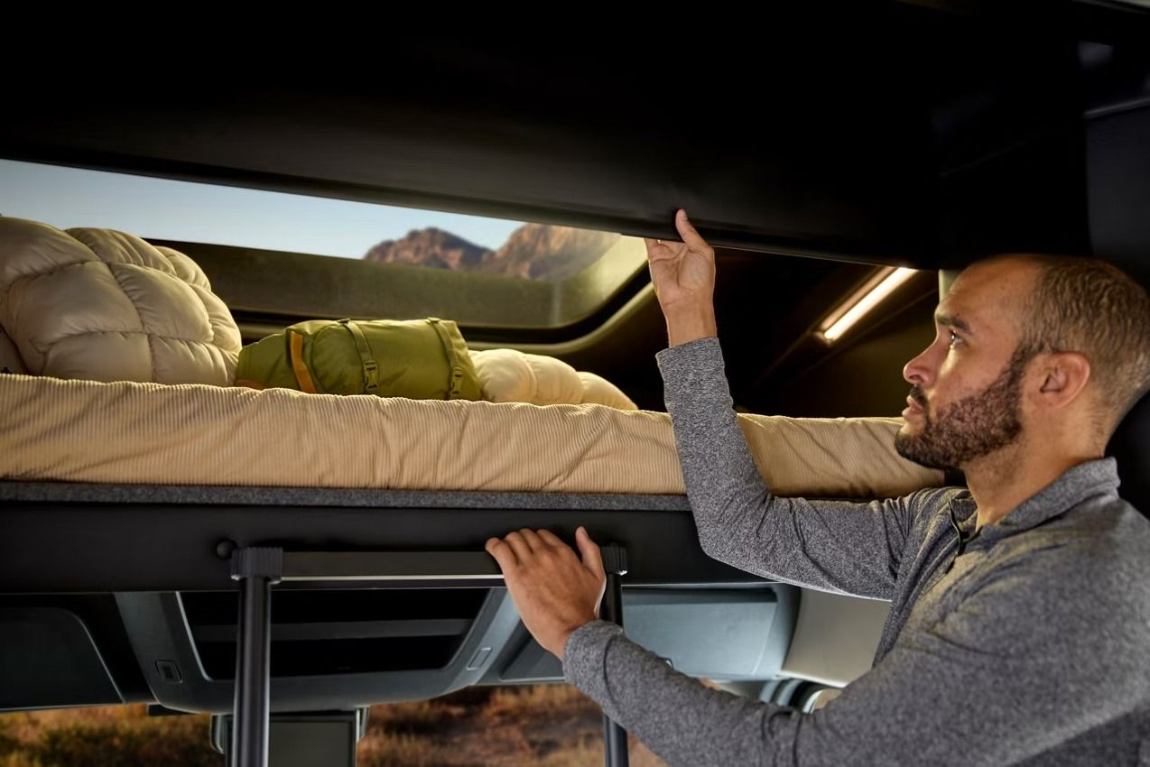 Man adjusting overcab bunk