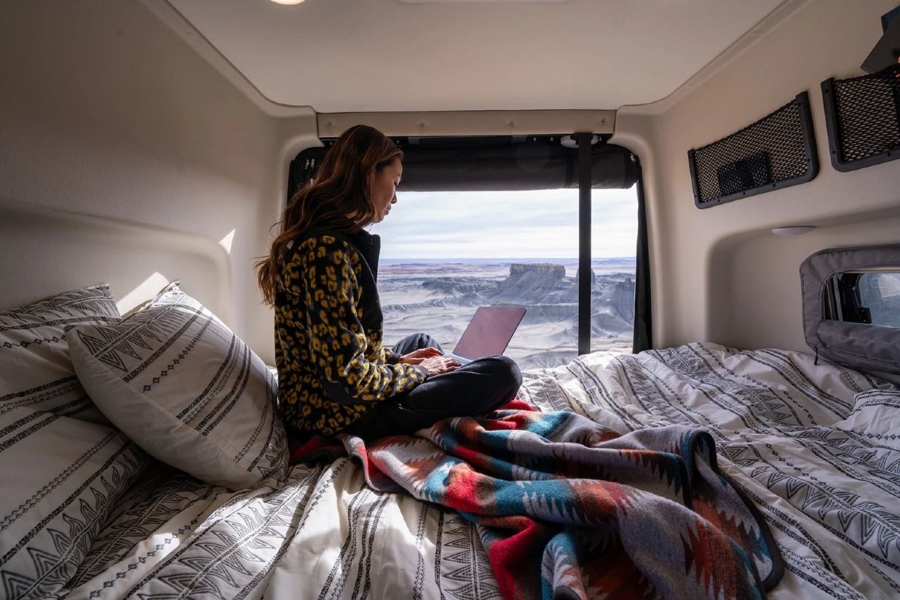 Woman in a bed inside an RV