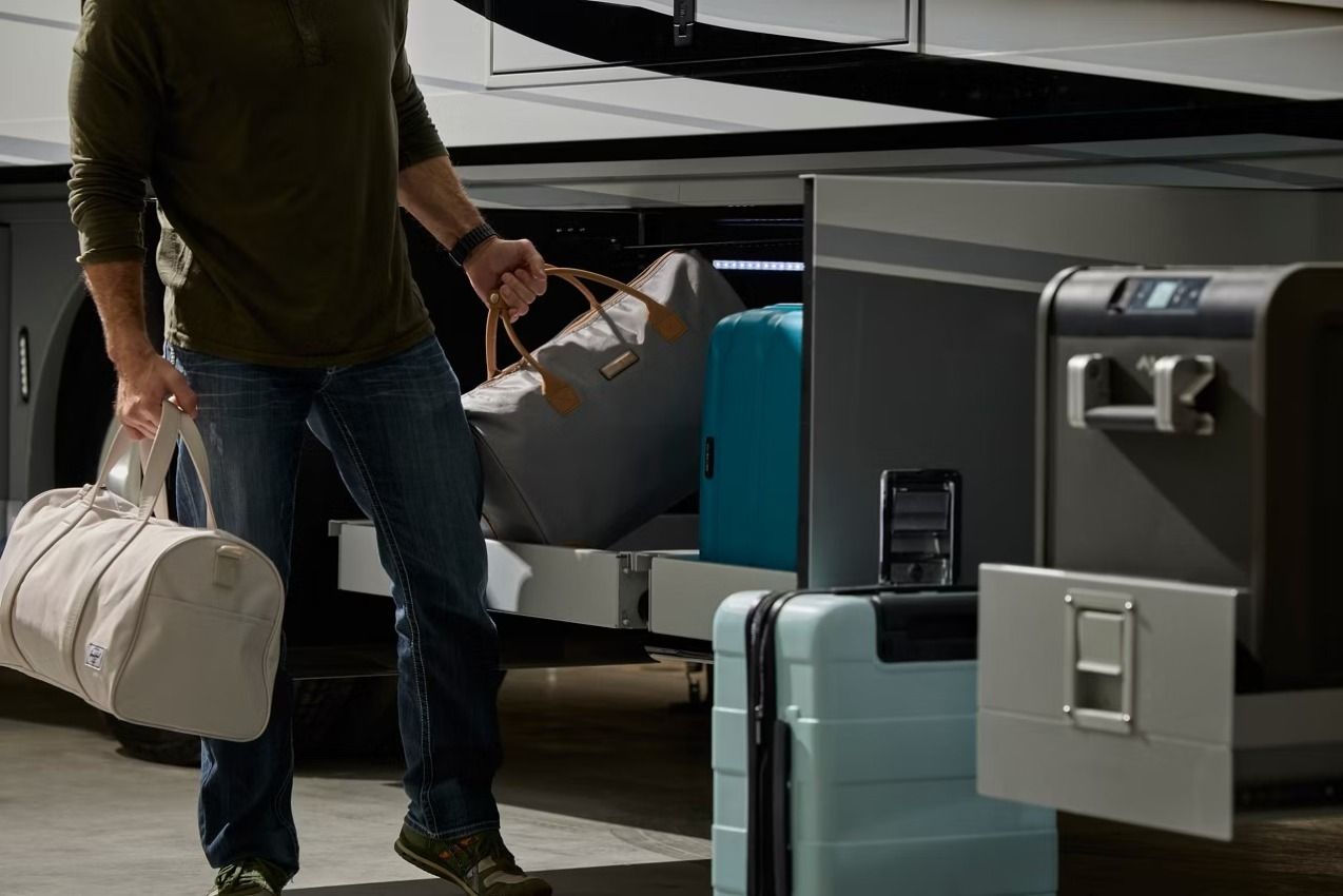2027 Newmar New Aire exterior storage with a person taking luggage