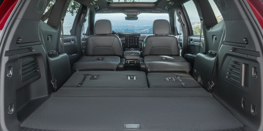26 GMC Acadia three-row interior with third row folded flat showing maximum cargo space available at Transwest GMC Henderson CO