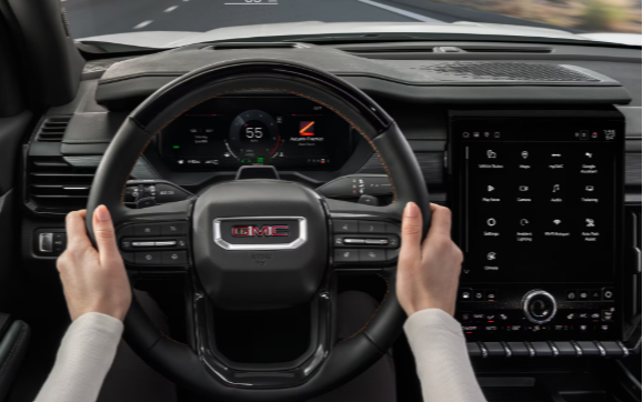 2026 GMC Acadia AWD Elevation interior featuring 15-inch GMC infotainment touchscreen and heads-up display at Transwest GMC Henderson CO