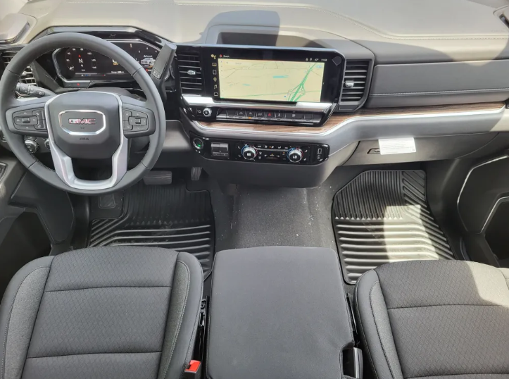Inside, steering wheel, and infotainment center of GMC Sierra 1500 Elevation at Transwest GMC in Henderson, Colorado