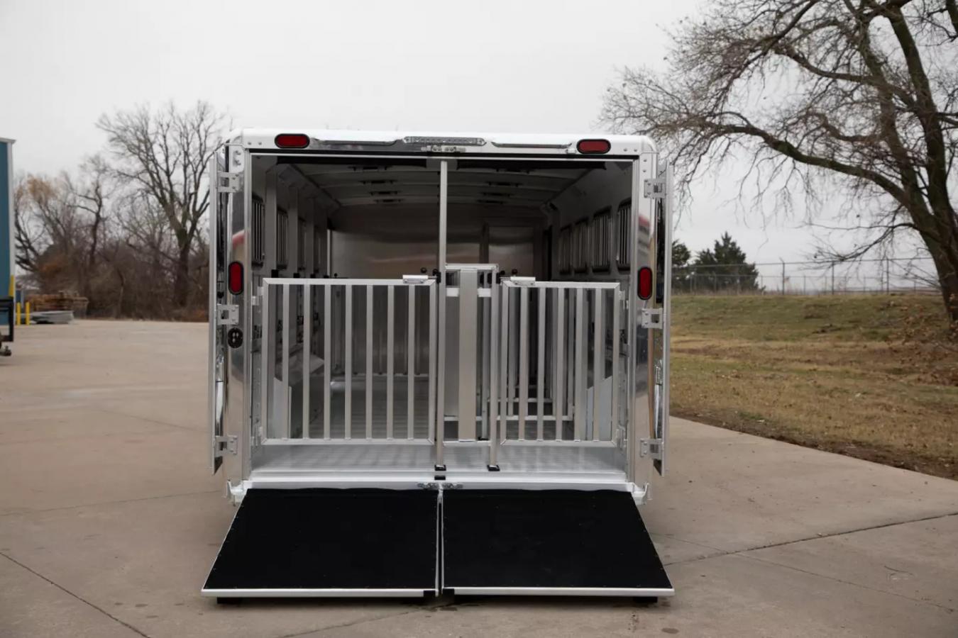 An exterior shot of the back of a Cimarron Trailer, featuring loading ramp and gate