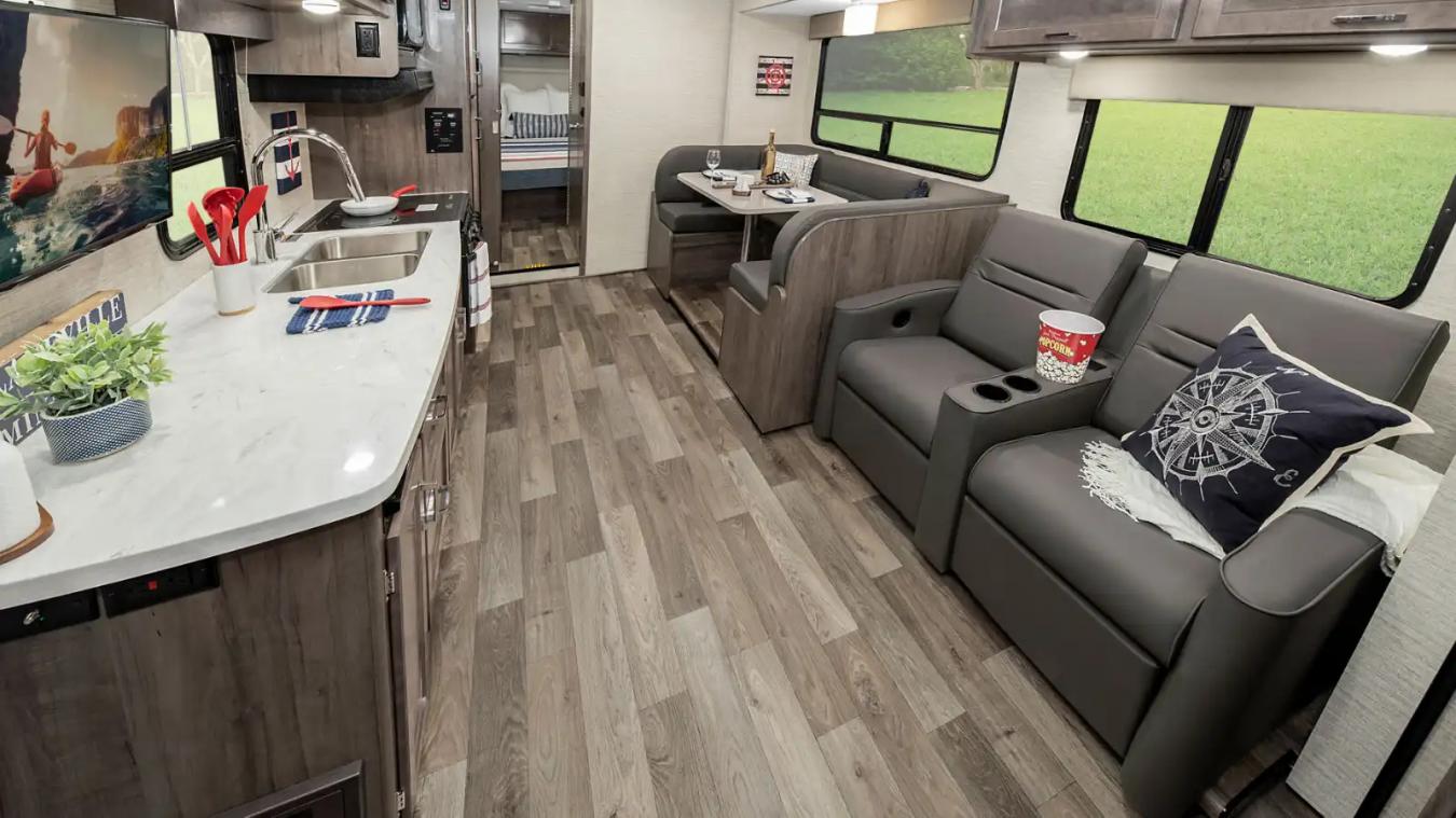 Interior shot of Winnebago RV, featuring kitchen area and living space
