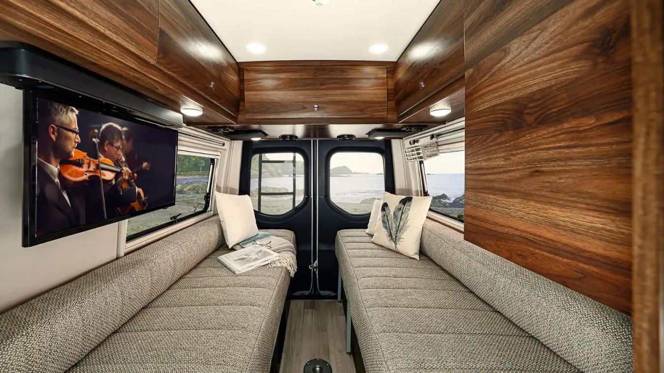 Interior shot of Winnebago RV, featuring two long couches that are facing each other