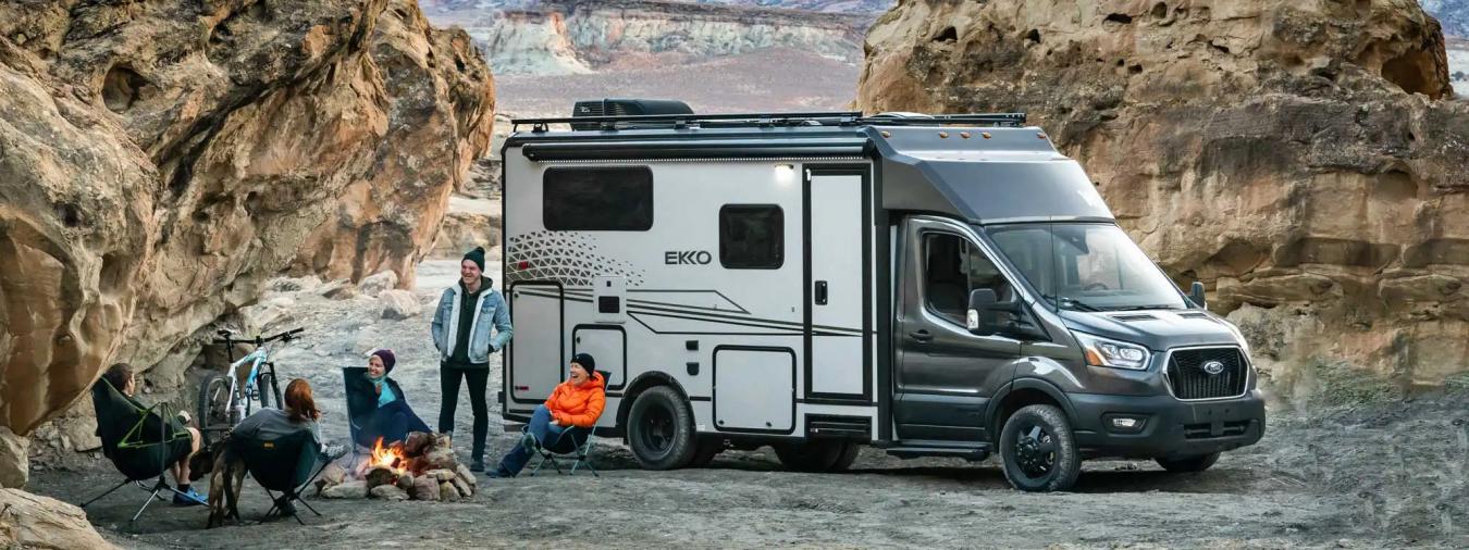 A family sitting with each other outside of a Winnebago Ekko RV