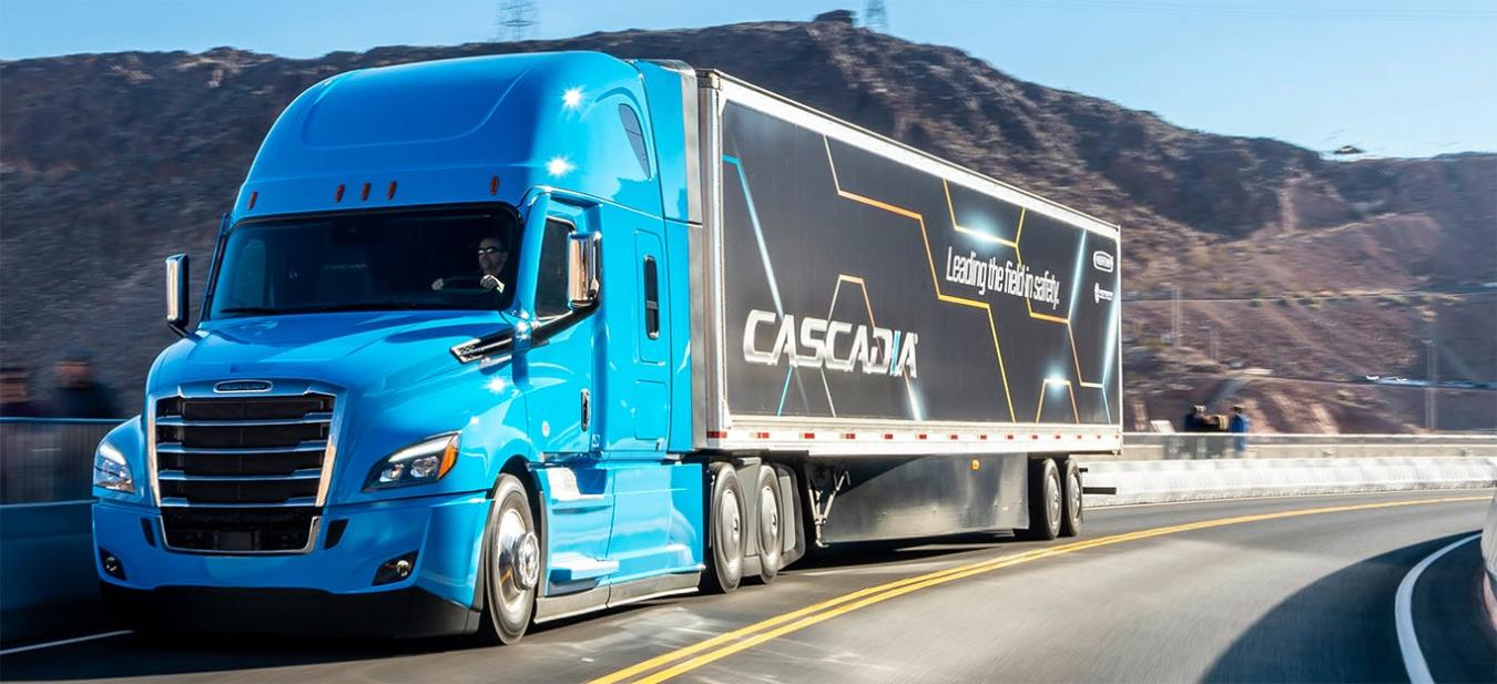 Blue Freightliner Cascada hauler on the highway