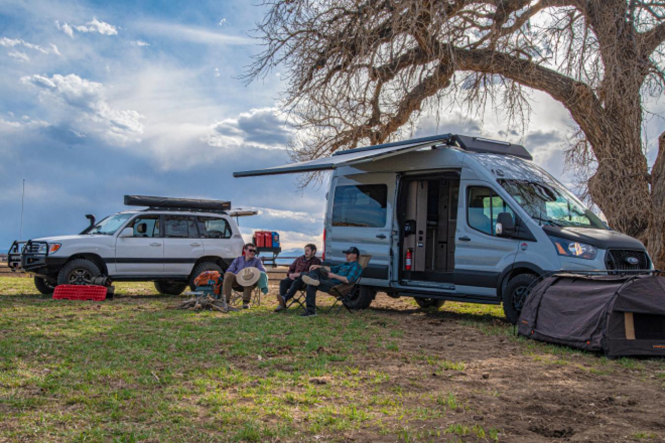 A group of friends sitting together outside of an Antero Adventure Van