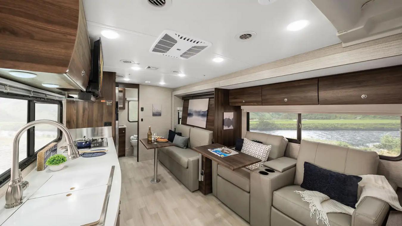Interior shot of a Winnebago RV, featuring the kitchen and living space