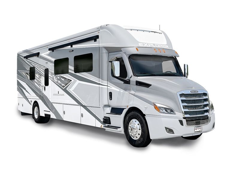 Exterior of the 2026 Renegade Explorer Super C motorhome in silver and gray full-body paint. Built on a Freightliner chassis with bold graphics and large side windows.