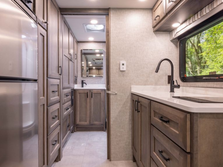 Interior view of the Midas sink, fridge, and cabinets