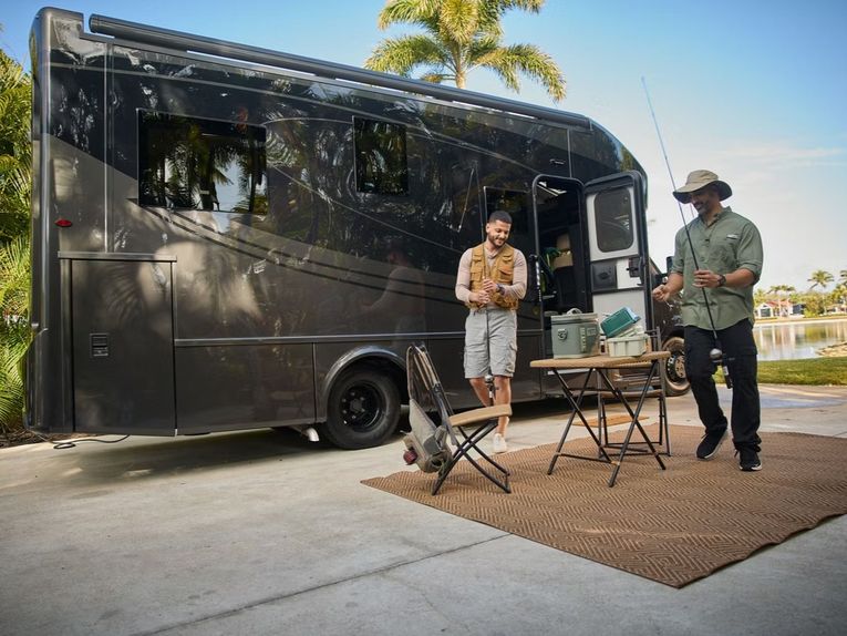 People outside a small RV