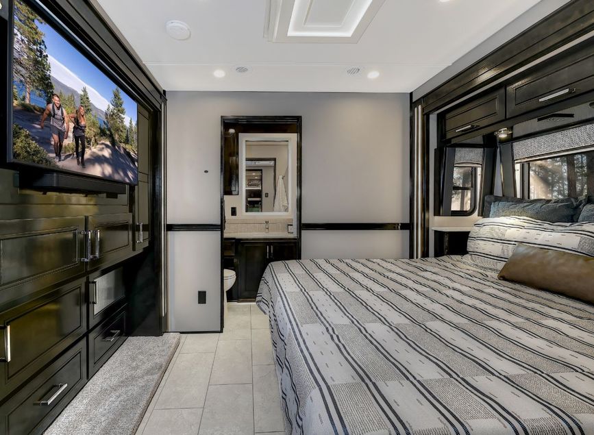 Plush bed and large TV inside the 2026 Renegade XL