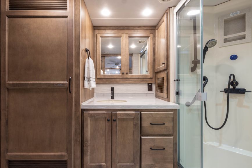 Bathroom, sink, mirror, and shower in the Tiffin Allegro RED