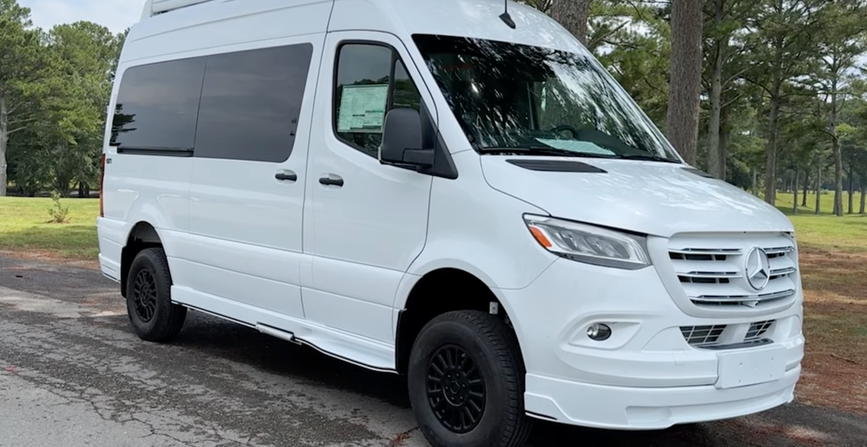 2026 Tiffin GT1 Touring Van exterior on a paved road with trees in the background