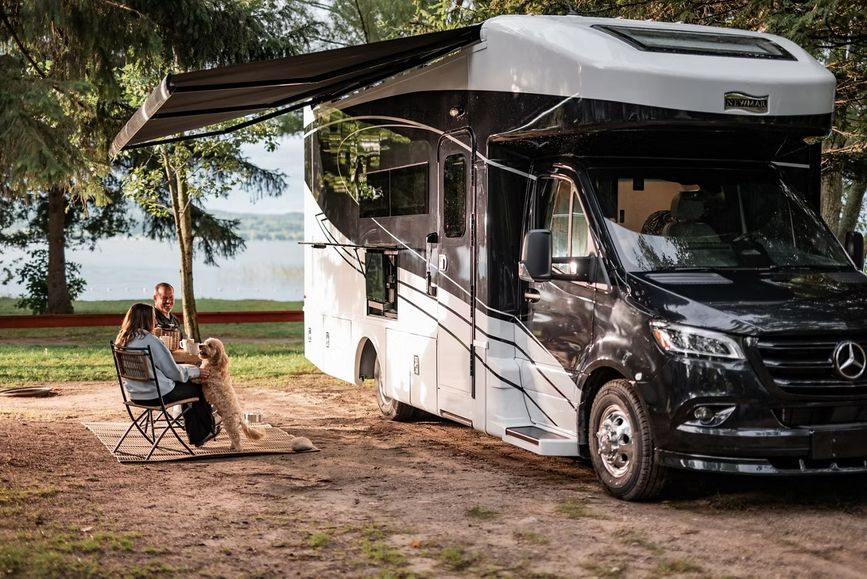 Couple outside a small RV