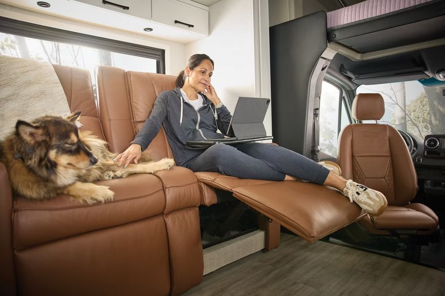 Woman and dog relaxing inside an RV