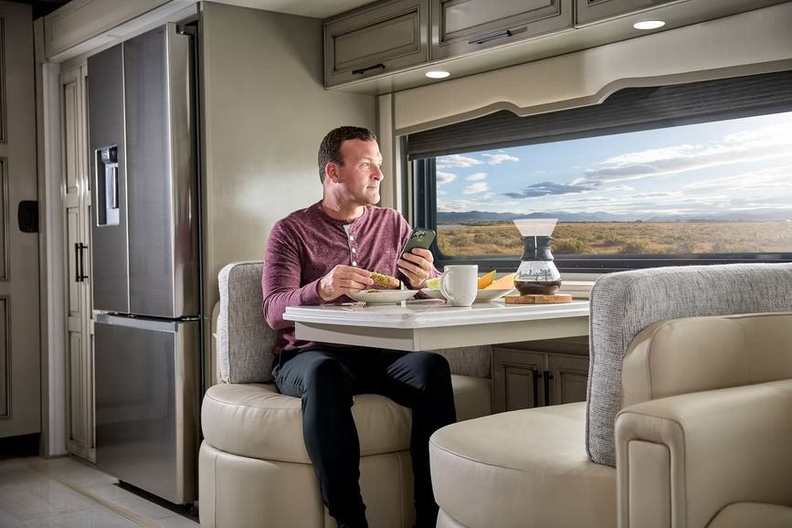 Man at a dinette inside an RV
