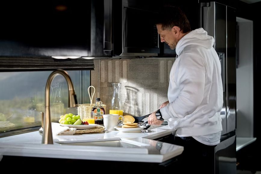 Person standing in front of the 2027 Newmar New Aire kitchen sink
