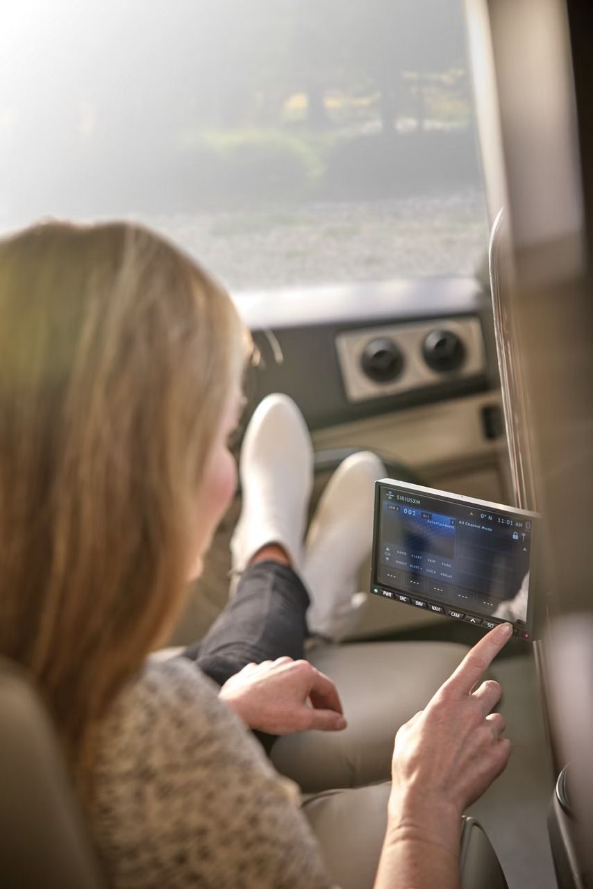 Person inside the 2027 Newmar Mountain Aire touching a screen