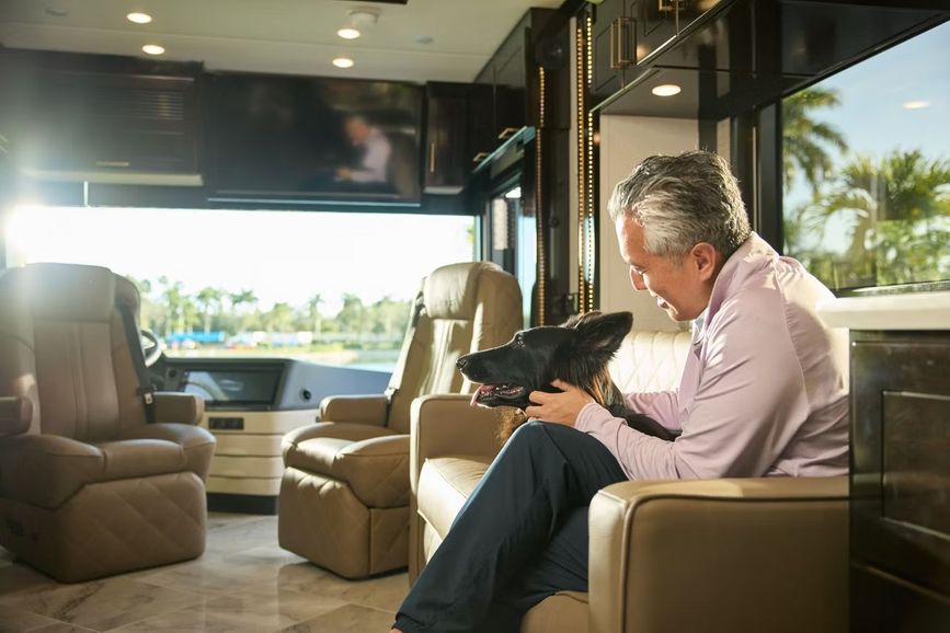 2027 Newmar Essex interior with a person sitting in a chair