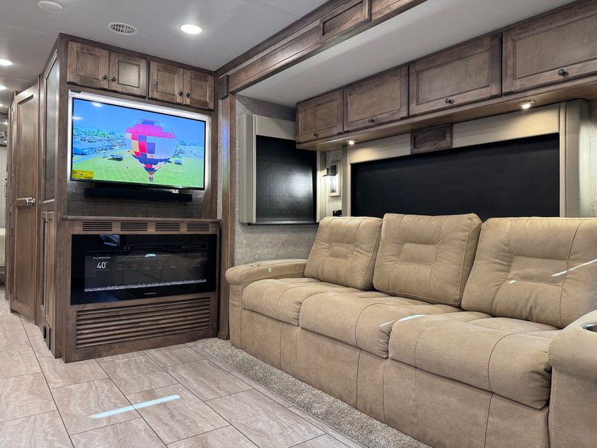 Fireplace and sofa inside the Open Road Allegro