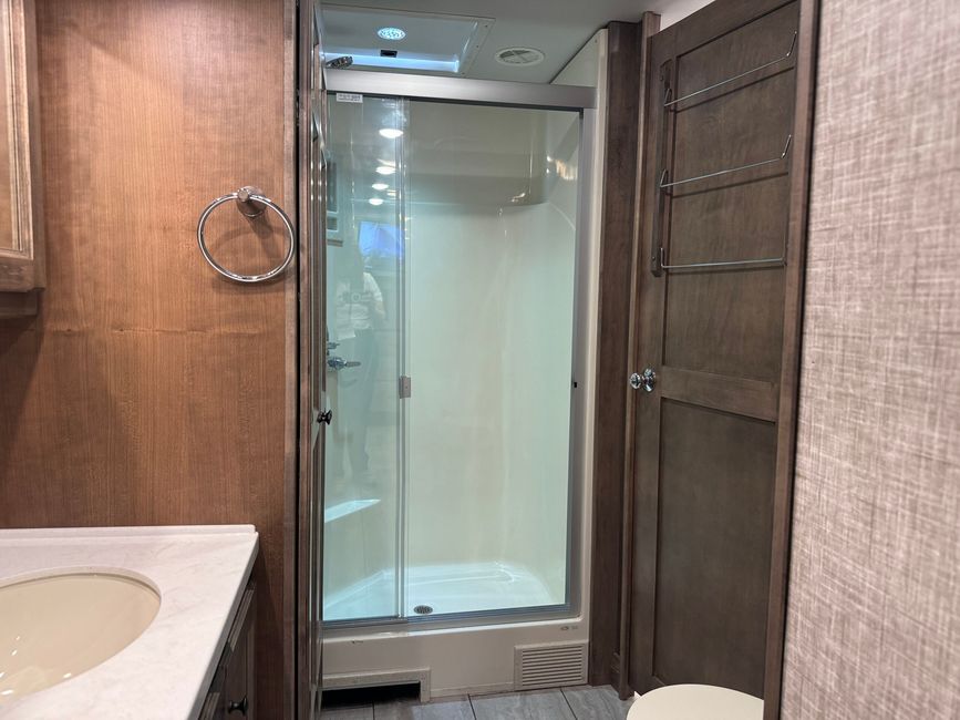 Shower and bathroom cabinetry inside the Open Road Allegro