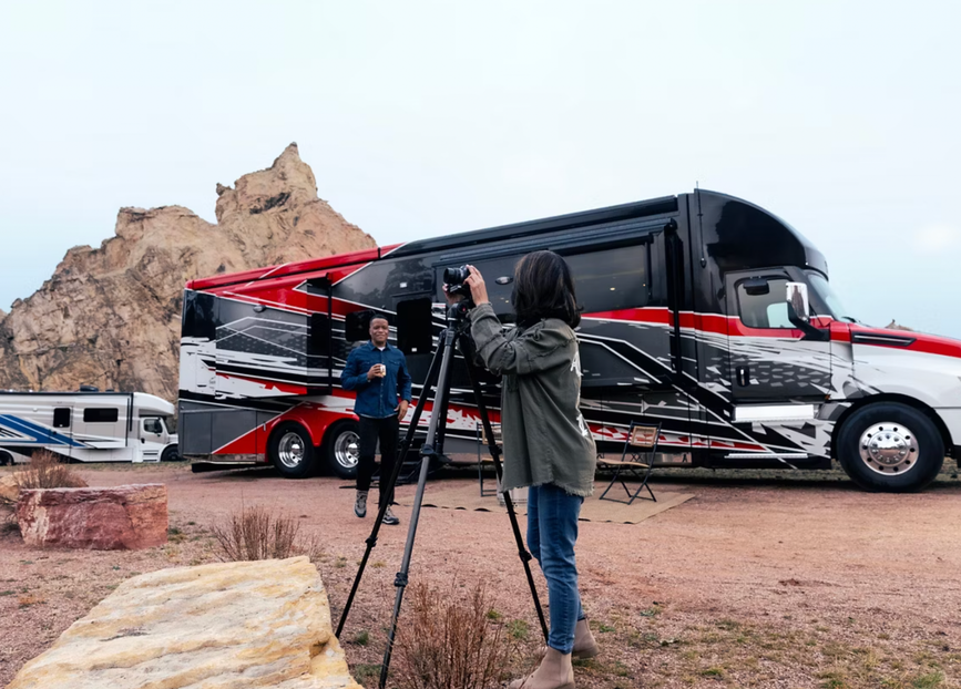 People take pictures in front of the 2026 Newmar Summit Aire