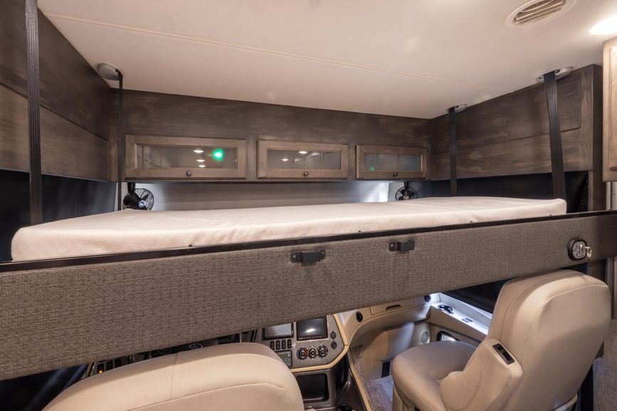 Overcab bunk and view of the dash from inside the Open Road Allegro