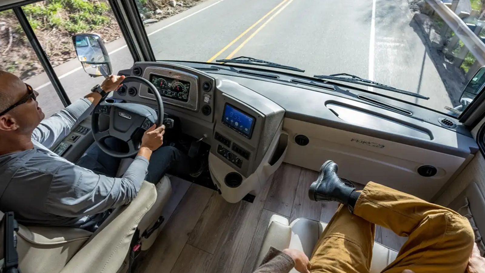 Two people driving in an RV