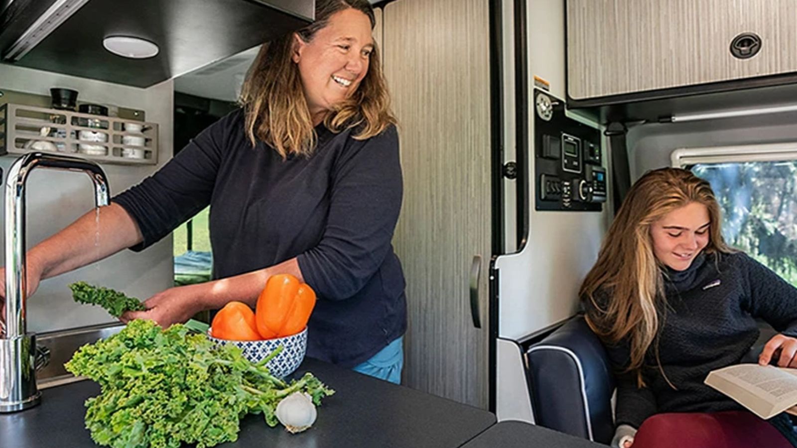 Mom and daughter cooking in an RV 