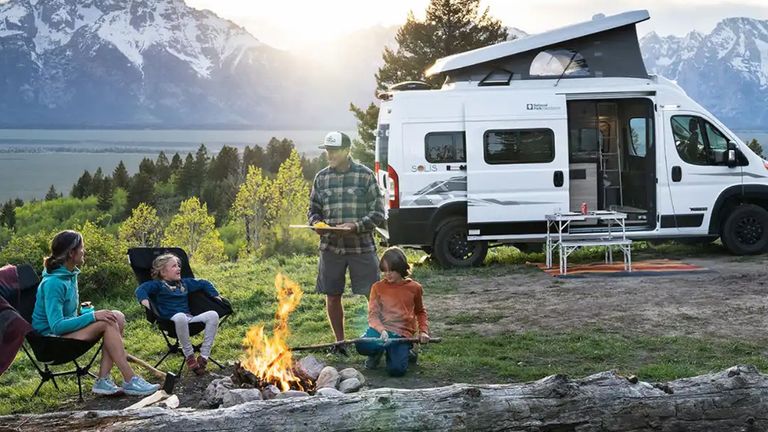 Family in nature by a campervan