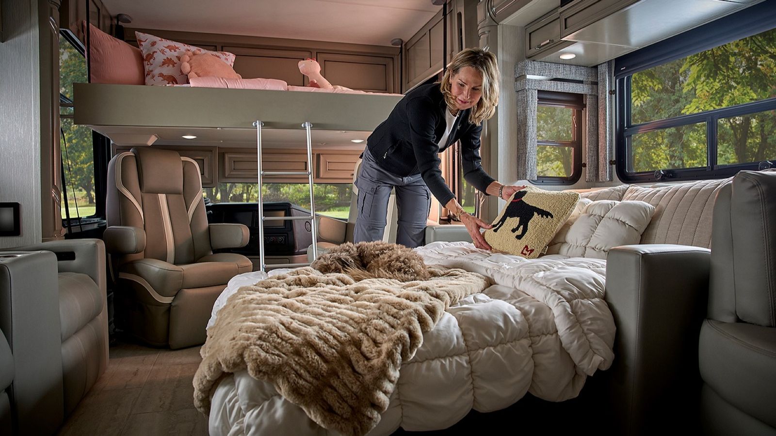 Woman makes a bed inside an RV