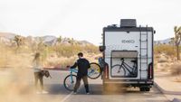 Couple unloading bikes from the EKKO in a desert scene